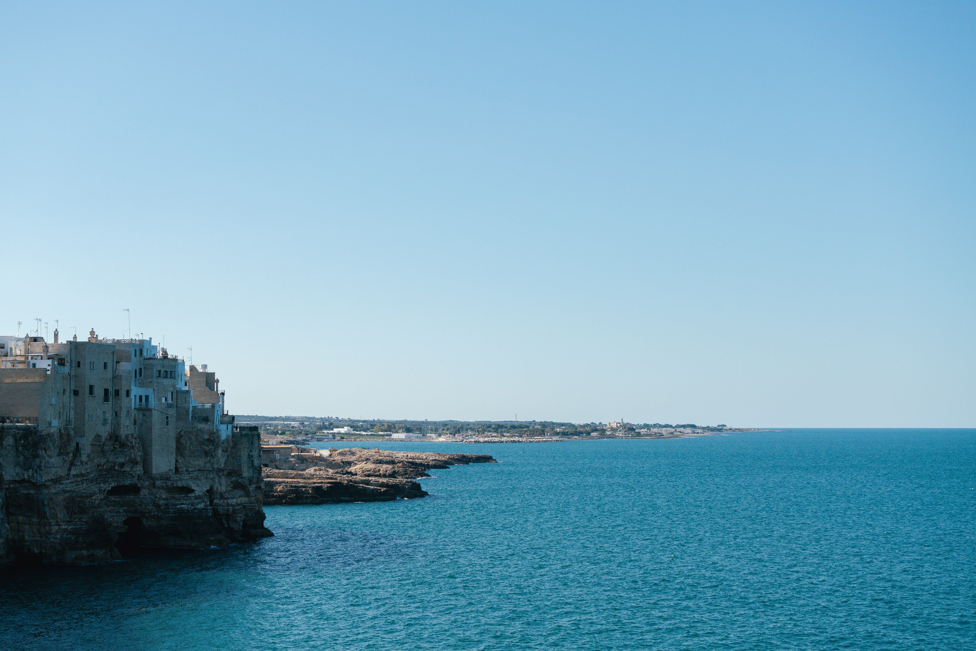 Bright coastal buildings beside blue sea