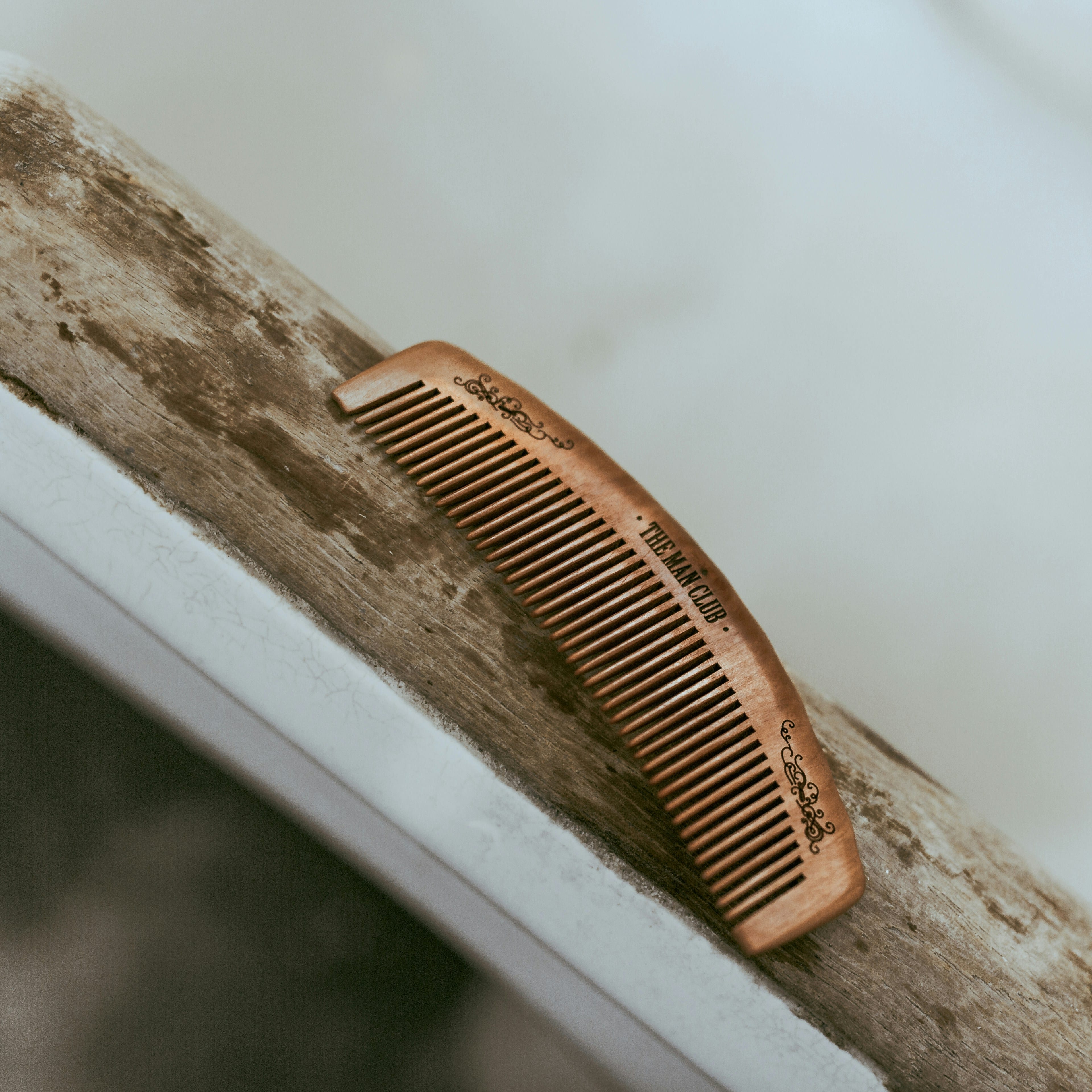 Brown grooming comb on a clean surface