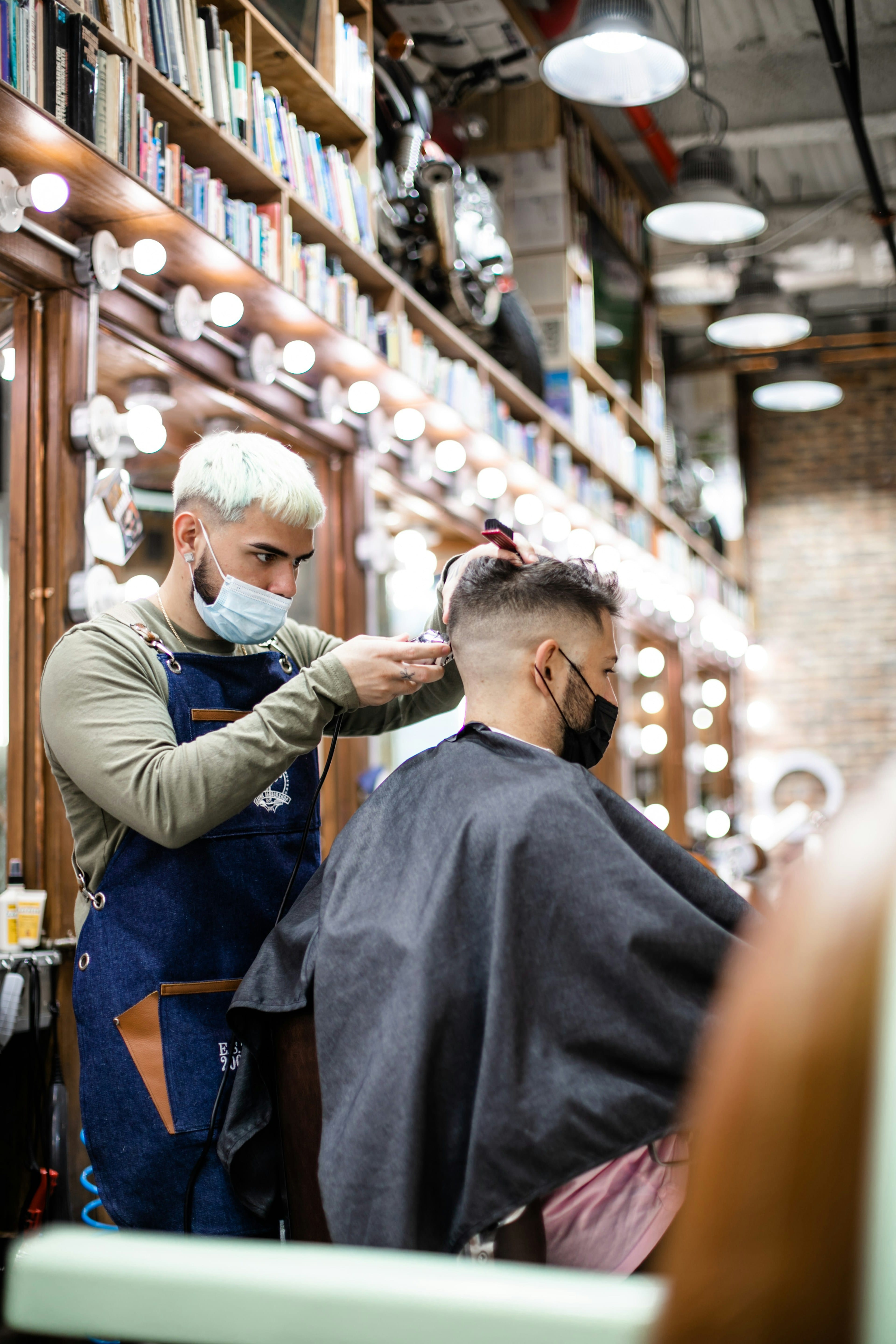 Barber styling a man's hair in a barbershop