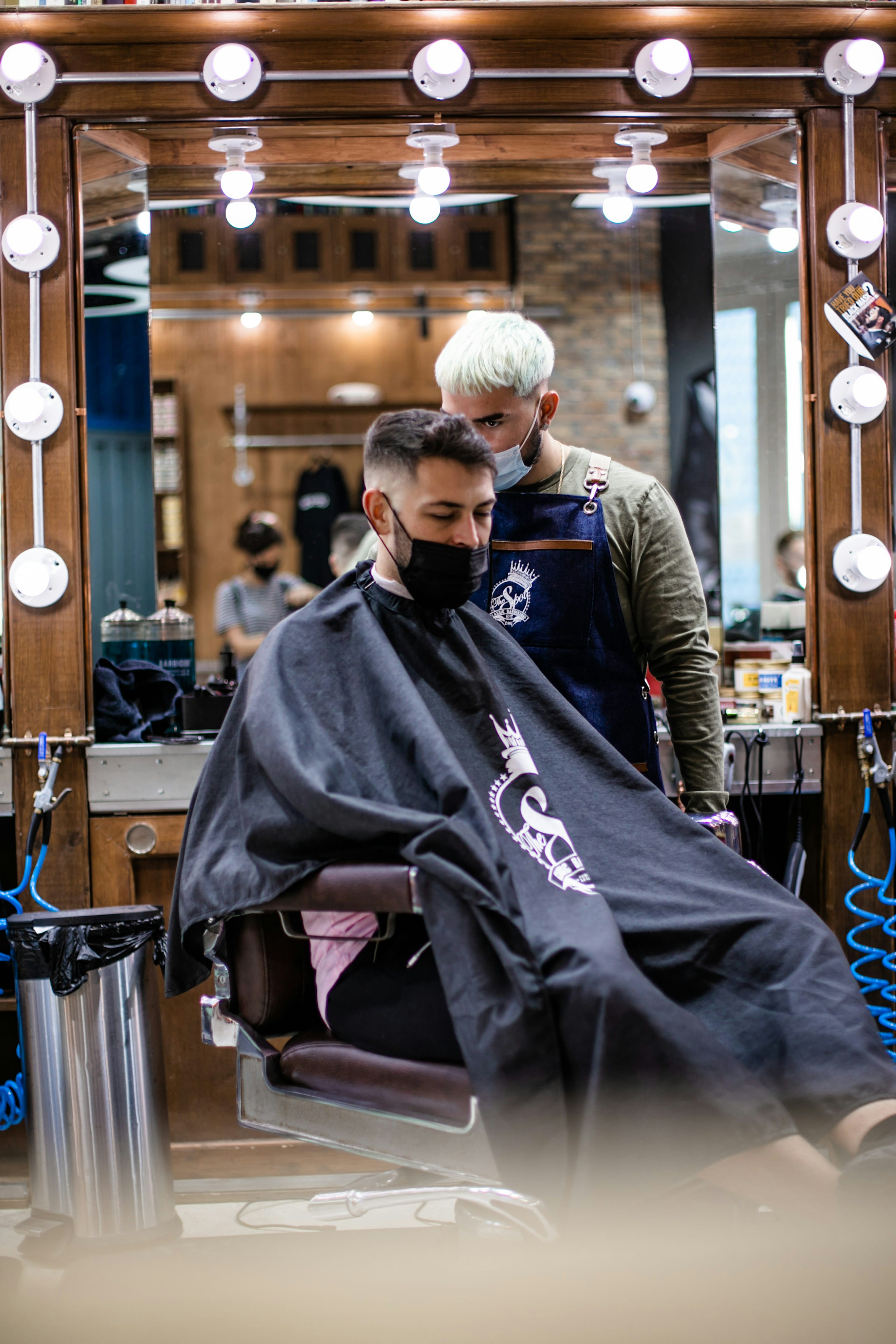 Client sitting in a barber chair in a modern shop