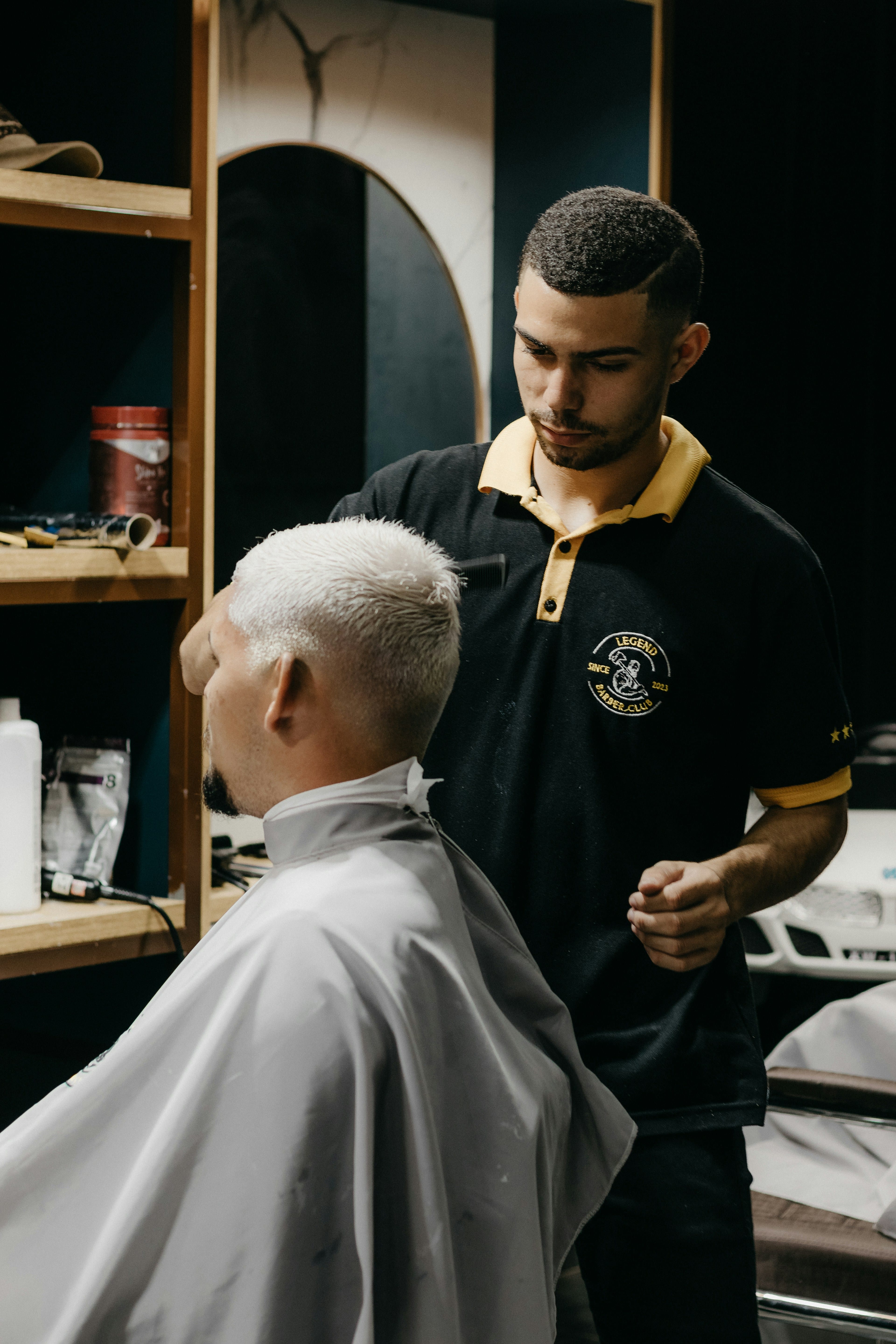 Man getting a modern haircut by a barber